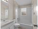 Bright bathroom featuring a vanity, toilet, tub, and tiled walls at 580 Tree Shore Dr, Orlando, FL 32825