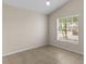 Sunlit bedroom featuring tile flooring, neutral walls, and a window with blind coverings at 580 Tree Shore Dr, Orlando, FL 32825