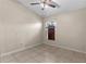 Bedroom showcasing a ceiling fan, window, and tile flooring at 580 Tree Shore Dr, Orlando, FL 32825