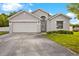 Charming single-Gathering home with a well-maintained lawn, two car garage, and neutral colored exterior at 580 Tree Shore Dr, Orlando, FL 32825