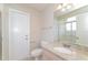 Clean bathroom featuring granite countertops and a shower-tub combo at 7763 Indian Ridge N Trl, Kissimmee, FL 34747