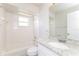 Bright bathroom featuring granite countertops, tile floors, and a shower-tub combo at 7763 Indian Ridge N Trl, Kissimmee, FL 34747