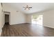 Spacious living room featuring vaulted ceilings, modern ceiling fan, and sliding glass doors at 7763 Indian Ridge N Trl, Kissimmee, FL 34747