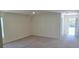 Inviting living room with neutral carpet and a bright front door leading to the outside at 53 Orchid Ct, Poinciana, FL 34759