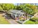 Aerial view of a charming gray home featuring a white picket fence and mature shade trees at 1309 Sanford Ave, Sanford, FL 32771