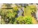 Aerial view of gray roof and a tree covered property with a paved road on the right at 1309 Sanford Ave, Sanford, FL 32771