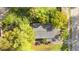 Birds eye view of the home featuring a gray roof nestled among mature green shade trees at 1309 Sanford Ave, Sanford, FL 32771