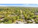 Wide aerial view showing the neighborhood with tree-lined streets and houses under a clear sky at 1309 Sanford Ave, Sanford, FL 32771
