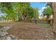 Spacious backyard enclosed by a wooden fence and dotted with mature shade trees at 1309 Sanford Ave, Sanford, FL 32771