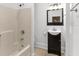 Bathroom featuring tile flooring, shower-tub combo and vanity with a dark wood cabinet at 1309 Sanford Ave, Sanford, FL 32771
