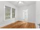Bright bedroom featuring hardwood floors, white walls, and a view to the bathroom at 1309 Sanford Ave, Sanford, FL 32771
