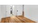Spacious bedroom featuring hardwood floors and white painted trim and bathroom entrance at 1309 Sanford Ave, Sanford, FL 32771