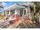 Welcoming front porch with brick columns, gray railings, and classic architectural details at 1309 Sanford Ave, Sanford, FL 32771