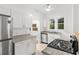 Clean kitchen featuring modern appliances, white cabinets, and natural light at 1309 Sanford Ave, Sanford, FL 32771