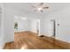 Bright living room featuring hardwood floors, white walls, and ceiling fans at 1309 Sanford Ave, Sanford, FL 32771