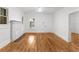 Inviting living room with gleaming hardwood floors, a brick fireplace, and fresh white walls at 1309 Sanford Ave, Sanford, FL 32771