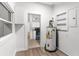 Utility room featuring laminate flooring and window for natural light, with a view to the kitchen at 1309 Sanford Ave, Sanford, FL 32771