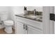 Bathroom featuring a granite countertop, a white cabinet, and a modern toilet at 760 S Park Ave, Winter Garden, FL 34787