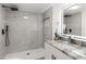 Modern bathroom features marble-look tile in the glass enclosed shower at 760 S Park Ave, Winter Garden, FL 34787