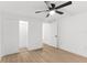 Bright bedroom features wood-look floors, a ceiling fan, and a closet with sliding doors at 760 S Park Ave, Winter Garden, FL 34787