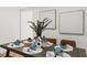 Beautiful dining room showcasing a tastefully set table, sleek chairs, and contemporary artwork at 760 S Park Ave, Winter Garden, FL 34787