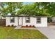 Charming single-story home with a well-manicured lawn and fresh landscaping, creating inviting curb appeal at 760 S Park Ave, Winter Garden, FL 34787