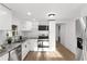 Bright kitchen features stainless appliances, gray countertops, and white cabinetry at 760 S Park Ave, Winter Garden, FL 34787