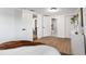 Open bedroom featuring wood floors, a view of a full bathroom and closet at 760 S Park Ave, Winter Garden, FL 34787