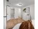 Bright bedroom features wood floors, a view of a full bathroom and closet at 760 S Park Ave, Winter Garden, FL 34787