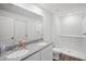 Well-lit bathroom boasts a double sink vanity with granite countertop and a walk-in shower, combining style with functionality at 540 Glade Ct, Kissimmee, FL 34758