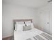 Cozy bedroom featuring a plush bed with white comforter, accent pillows, and a view of the closet at 540 Glade Ct, Kissimmee, FL 34758