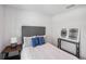 Comfortable bedroom with a bed featuring patterned pillows, side tables, and decorative artwork at 540 Glade Ct, Kissimmee, FL 34758