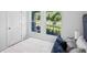 Comfortable bedroom featuring a plush bed with patterned pillows and a view from a window showing lush greenery at 540 Glade Ct, Kissimmee, FL 34758