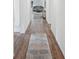 Bright hallway featuring hardwood floors and a decorative rug leading to a cozy living room at 540 Glade Ct, Kissimmee, FL 34758