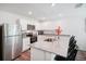 Contemporary kitchen with white cabinets, stainless steel appliances, and a spacious granite countertop at 540 Glade Ct, Kissimmee, FL 34758
