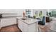 Bright kitchen with stainless appliances, white cabinets, granite countertops, and a view to the dining area at 540 Glade Ct, Kissimmee, FL 34758