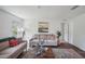 Comfortable living room featuring stylish sofas, a decorative rug, and ample natural light at 540 Glade Ct, Kissimmee, FL 34758