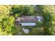 Birds-eye view of the home showcasing the roof, yard, and mature trees at 1915 Poinsettia Dr, Port Orange, FL 32128