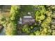 Aerial view of house showing the roof and surrounding treed lot at 1915 Poinsettia Dr, Port Orange, FL 32128