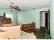 Bedroom with bed, desk, and view of natural light from window at 1915 Poinsettia Dr, Port Orange, FL 32128