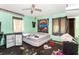 Bedroom with mint green walls, with natural light from windows and ceiling fan at 1915 Poinsettia Dr, Port Orange, FL 32128