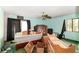 Bedroom with a king size bed, ceiling fan, and view of natural light at 1915 Poinsettia Dr, Port Orange, FL 32128