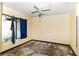 Bedroom featuring a window, ceiling fan, and damage to the walls and floor at 1915 Poinsettia Dr, Port Orange, FL 32128