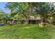 Exterior view of a home with a grassy lawn and trees surrounding it at 1915 Poinsettia Dr, Port Orange, FL 32128