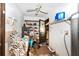 View of cluttered laundry room area with shelving, washer and dryer hookups, and ceiling fan at 1915 Poinsettia Dr, Port Orange, FL 32128