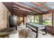 Enclosed patio featuring a brick wall, tile floor, and a billiards table at 1915 Poinsettia Dr, Port Orange, FL 32128