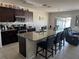 Features a modern kitchen with stainless steel appliances and a granite countertop island with barstool seating at 308 Aberdeen Dr, Davenport, FL 33896