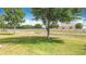 Scenic backyard view with canal, mature trees, and a tranquil setting at 3514 Yacht Club Ct, Kissimmee, FL 34746