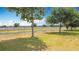 Enjoy lush backyard views from this home with scenic canal, mature trees and green lawn at 3514 Yacht Club Ct, Kissimmee, FL 34746