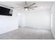 Bright living room features tile flooring, modern ceiling fan, and wall-mounted television at 3514 Yacht Club Ct, Kissimmee, FL 34746